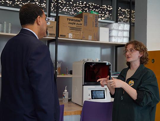 woman talking with man in suit and tie